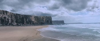 Movie still from “Robin Hood” (2010), directed by Ridley Scott – A view of the ocean from the beach with waves coming to shore; Extreme Wide shot, High angle