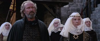 Movie still from “Robin Hood” (2010), directed by Ridley Scott – A group of people dressed in medieval clothing; Medium shot, Over the shoulder angle
