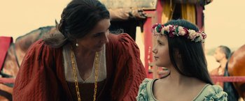 Movie still from “Benedetta” (2021), directed by Paul Verhoeven – A woman talking to a young girl wearing a flower crown; Close Up shot, Over the shoulder angle