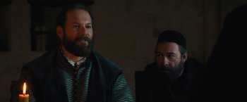Movie still from “Benedetta” (2021), directed by Paul Verhoeven – Two bearded men are standing in a room; Medium shot, Over the shoulder angle