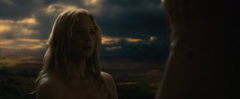 Movie still from “Benedetta” (2021), directed by Paul Verhoeven – A woman standing in front of a cloudy sky at night; Close Up shot, Over the shoulder angle