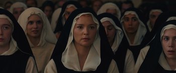 Movie still from “Benedetta” (2021), directed by Paul Verhoeven – A group of people wearing black and white clothing; Close Up shot, High angle