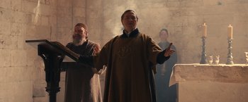 Movie still from “Benedetta” (2021), directed by Paul Verhoeven – A group of men standing next to each other in a room; Medium shot, Low angle