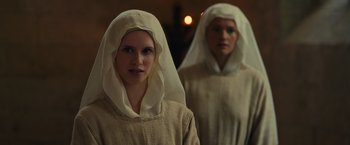 Movie still from “Benedetta” (2021), directed by Paul Verhoeven – Two women dressed as nuns standing next to each other; Close Up shot, Low angle
