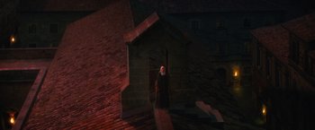 Movie still from “Benedetta” (2021), directed by Paul Verhoeven – An old man standing in front of a brick building; Extreme Wide shot, High angle