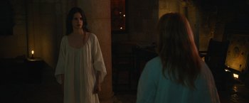 Movie still from “Benedetta” (2021), directed by Paul Verhoeven – A woman in a white dress standing in front of a mirror; Medium shot, Over the shoulder angle