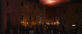 Movie still from “Benedetta” (2021), directed by Paul Verhoeven – A crowd of people gathered around a crucifixion statue; Extreme Wide shot, Low angle