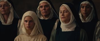 Movie still from “Benedetta” (2021), directed by Paul Verhoeven – A group of three people wearing nun's clothes; Close Up shot, High angle