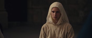 Movie still from “Benedetta” (2021), directed by Paul Verhoeven – A woman wearing a head scarf and a robe; Close Up shot, Low angle