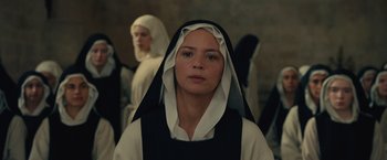 Movie still from “Benedetta” (2021), directed by Paul Verhoeven – A woman in a nun's outfit standing next to another woman; Close Up shot, Low angle