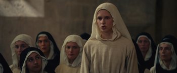 Movie still from “Benedetta” (2021), directed by Paul Verhoeven – Two women dressed as nuns standing next to each other; Close Up shot, Low angle