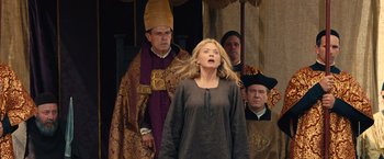 Movie still from “Benedetta” (2021), directed by Paul Verhoeven – A man and a woman standing next to each other in front of two other men; Medium shot, Low angle