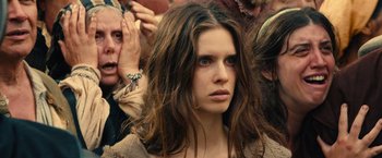 Movie still from “Benedetta” (2021), directed by Paul Verhoeven – A person with long brown hair; Close Up shot, Over the shoulder angle