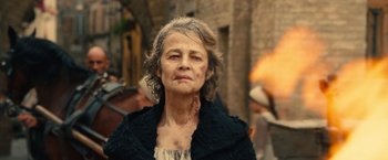 Movie still from “Benedetta” (2021), directed by Paul Verhoeven – An older woman with a lot of scars on her face; Close Up shot, Over the shoulder angle