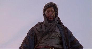 Movie still from “Robin Hood: Prince of Thieves” (1991), directed by Kevin Reynolds – A man wearing a turban and wearing a scarf; Close Up shot, Low angle