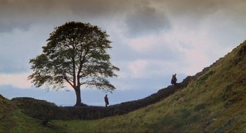 Movie still from “Robin Hood: Prince of Thieves” (1991), directed by Kevin Reynolds – Two people are standing on a hill near a tree; Extreme Wide shot, High angle