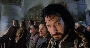 Movie still from “Robin Hood: Prince of Thieves” (1991), directed by Kevin Reynolds – A group of people standing in a room; Close Up shot, Low angle