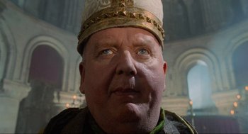 Movie still from “Robin Hood: Prince of Thieves” (1991), directed by Kevin Reynolds – A person wearing a hat; Close Up shot, Low angle