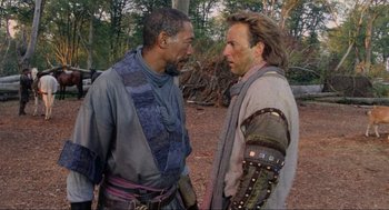 Movie still from “Robin Hood: Prince of Thieves” (1991), directed by Kevin Reynolds – Two men in medieval garb talking to each other in the woods; Medium shot, Over the shoulder angle