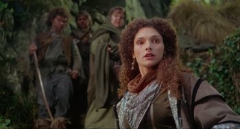 Movie still from “Robin Hood: Prince of Thieves” (1991), directed by Kevin Reynolds – A group of people standing next to each other in a forest; Medium shot, Low angle