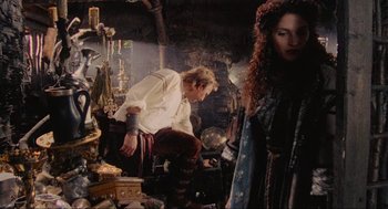 Movie still from “Robin Hood: Prince of Thieves” (1991), directed by Kevin Reynolds – A man and a woman in medieval garb in a room; Medium shot, Low angle