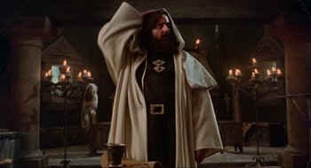 Movie still from “Robin Hood: Prince of Thieves” (1991), directed by Kevin Reynolds – A bearded man in a robe and a cape; Medium shot, Low angle