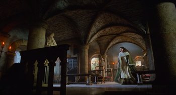 Movie still from “Robin Hood: Prince of Thieves” (1991), directed by Kevin Reynolds – A woman dressed in medieval clothing in a room with arches; Wide shot, Low angle