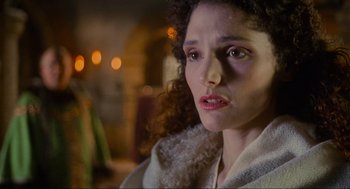 Movie still from “Robin Hood: Prince of Thieves” (1991), directed by Kevin Reynolds – A person with curly hair looking at the camera; Close Up shot, Over the shoulder angle