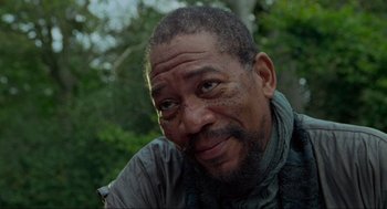 Movie still from “Robin Hood: Prince of Thieves” (1991), directed by Kevin Reynolds – An older man is smiling for the camera; Close Up shot, Low angle