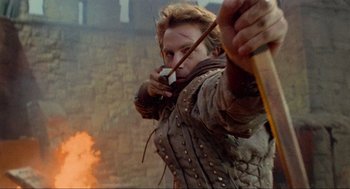 Movie still from “Robin Hood: Prince of Thieves” (1991), directed by Kevin Reynolds – A man is holding a bow and arrow in his hand; Close Up shot, Over the shoulder angle