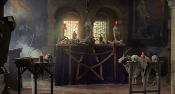Movie still from “Robin Hood: Prince of Thieves” (1991), directed by Kevin Reynolds – A table with skulls on top of it; Wide shot, High angle