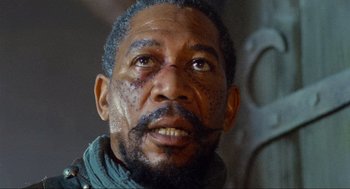 Movie still from “Robin Hood: Prince of Thieves” (1991), directed by Kevin Reynolds – An older man with a beard and a mustache; Close Up shot, Low angle