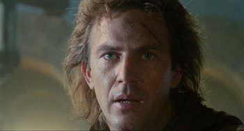 Movie still from “Robin Hood: Prince of Thieves” (1991), directed by Kevin Reynolds – A person with long brown hair; Close Up shot, Low angle