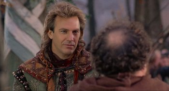 Movie still from “Robin Hood: Prince of Thieves” (1991), directed by Kevin Reynolds – A man with long hair is looking into a mirror; Close Up shot, Over the shoulder angle