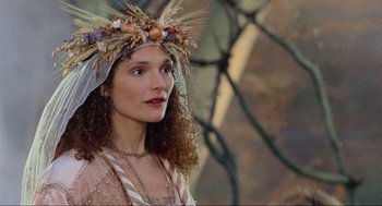 Movie still from “Robin Hood: Prince of Thieves” (1991), directed by Kevin Reynolds – A woman wearing a wreath of flowers on top of her head; Close Up shot, Low angle