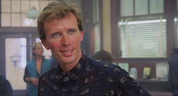 Movie still from “RoboCop” (1987), directed by Paul Verhoeven – A person wearing a button up shirt; Close Up shot, Low angle