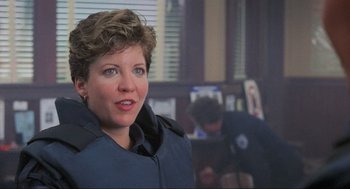 Movie still from “RoboCop” (1987), directed by Paul Verhoeven – A person with short hair; Close Up shot, Over the shoulder angle