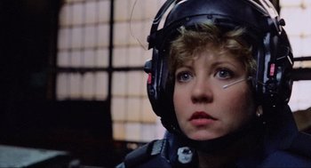Movie still from “RoboCop” (1987), directed by Paul Verhoeven – A woman wearing a black helmet and a black jacket; Close Up shot, Low angle