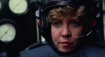 Movie still from “RoboCop” (1987), directed by Paul Verhoeven – A woman wearing a helmet and smoking a cigarette; Close Up shot, Low angle