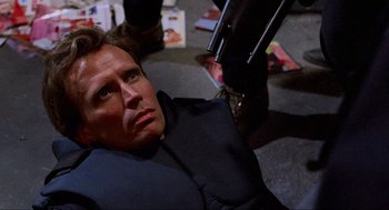 Movie still from “RoboCop” (1987), directed by Paul Verhoeven – A man in black jacket looking up at the sky; Close Up shot, High angle