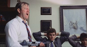 Movie still from “RoboCop” (1987), directed by Paul Verhoeven – A man and a young boy in suits and ties; Medium shot, Low angle