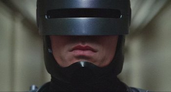 Movie still from “RoboCop” (1987), directed by Paul Verhoeven – A person wearing a helmet; Close Up shot, Low angle