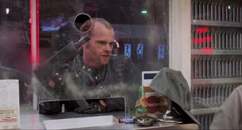 Movie still from “RoboCop” (1987), directed by Paul Verhoeven – A man sitting in front of an open window; Close Up shot, Over the shoulder angle