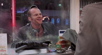 Movie still from “RoboCop” (1987), directed by Paul Verhoeven – A man sitting in front of a window; Close Up shot, Over the shoulder angle