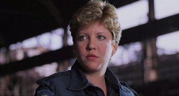 Movie still from “RoboCop” (1987), directed by Paul Verhoeven – A person with short blonde hair; Close Up shot, Low angle