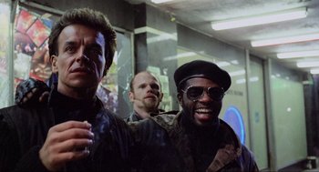 Movie still from “RoboCop” (1987), directed by Paul Verhoeven – A group of men standing next to each other in a room; Close Up shot, Low angle