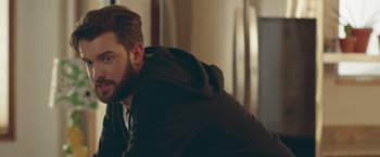 Movie still from “Robots” (2023), directed by Casper Christensen – A person wearing a jacket; Close Up shot, Over the shoulder angle