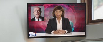 Movie still from “Robots” (2023), directed by Casper Christensen – A woman in front of a tv with an image of a man in front of her; Close Up shot, Over the shoulder angle