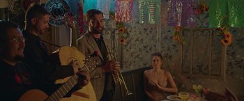 Movie still from “Robots” (2023), directed by Casper Christensen – A man and a woman playing instruments in a room; Medium shot, Low angle