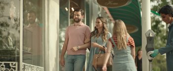 Movie still from “Robots” (2023), directed by Casper Christensen – A man and a woman walking down a street; Medium shot, Over the shoulder angle